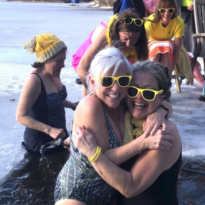 Hugging at 2024’s Wander Women’s dip in Union are Carla Armbuster and Carol Miller. In back, left to right , are Cathy Kelly, Kerry Hadley, Emily Peckham, and Laura Cabot. This year's event will be held on Feb. 9.  Photo by Erja Lipponen