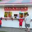 The young visitor on the left holds his hand out to is dad for money to spend at the Snack Shack operated by the Wiscasset High School All-Sports Boosters Club. KATHY ONORATO/Wiscasset Newspaper 