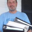 Sheepscot Valley Conservation Association board member Paul Hoffman holds a portion of the submissions required for the Land Trust Accreditation. Courtesy of Sheepscot Valley Conservation Association