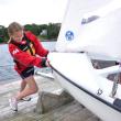 Madison Gaudette pushes in her 420 with the help of her skipper Jessica Murphy (not pictured). The Boothbay Harbor Yacht Club's Andy Holmes and Boothbay Region High School Club Sailing Team Head Coach Sally Lloyd said they would like to see the club affiliated with the high school. BEN BULKELEY/Boothbay Register