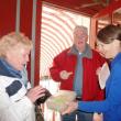 Nancy Gilchrist, right, offers a St. Patrick’s Day cookie to Joyce Tomecko of Rhode Island while John Appleton looks on. KATRINA CLARK/Boothbay Register