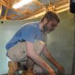 Colin Marshall places rocks in a tank as opening day draws near for the Maine State Aquarium. BEN BULKELEY/Boothbay Register.