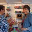 Linda Estabrook, left, and Pam Shockley help set up the Maine Craft Shack on the creamery pier on the waterfront in Wiscasset May 20. Estabrook, Shockley and three other women have a cooperative through which several other crafters' items are also sold. The shack opens Friday, May 24. SUSAN JOHNS/Wiscasset Newspaper