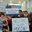 The Greenleaf and Leighton families hold signs welcoming their soldiers home from Afghanistan. Courtesy of Isaac Luken