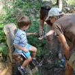 Nan Davison, BRLT Stewardship Campaign Chairman, learns about one of nature’s small wonders with her grandson Graydon on a recent Boothbay Region Land Trust hike at Ocean Point Preserve. BRLT environmental educator Tracey Hall leads a family hike at a land trust preserve the second Saturday of every month. Courtesy of Boothbay Region Land Trust