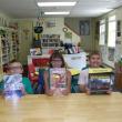 Emmitt, Maria and Gavin show the books from the Children’s Room Geology Collection. Courtesy of Judy Flanagan