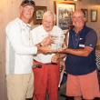 Ken Colburn, left, winner of the Division One series in the Boothbay Harbor Yacht Club Regatta sailing his Swan 42, Apparition. Colburn is being congratulated by BHYC Commodore  Neil Newton (right) and PC Andy Holmes, Regatta chair. Courtesy of Don Snyder