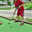 A young boy participates in a previous Maine State Minigolf Open at Dolphin Mini Golf in Boothbay. KEVIN BURNHAM/Boothbay Register