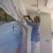 Artist Jane Dahmen hangs her contribution to the DRA's 40th anniversary art show, “Visions of the River,” which runs August 10-17 in Damariscotta. Courtesy of Damariscotta River Association