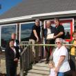 Ribbon-cutting participants at Atlas-Micro September 23 are, clockwise from left, Wiscasset Area Chamber of Commerce board member Patricia Stauble, Wiscasset Selectman Pam Dunning, the chamber board's chairman David Stapp, Atlas-Micro co-owner Enrique Pinero, Selectmen's Chairman Ed Polewarczyk, the business' co-owner Harry DeLoe, chamber board member Monique McRae, Town Planner Misty Parker, Selectman Judy Colby, and Colby's granddaughter Desirae Colby, 3. SUSAN JOHNS/Wiscasset Newspaper