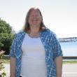 BARBARA ROSS on the front lawn of her Boothbay Harbor home, with the town's footbridge in the background. KEVIN BURNHAM/Boothbay Register