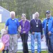 The top four finishers. Accompanied by tournament “mascot,”Addie Barter, left, the top four finishers of the 20th annual Dolphin Mini Golf Open stand together after the tournament. From left are Lee Stoddard (fourth), Nancy Gilchrist (third), Peter Gilchrist (second) and Joshua Tiberio (first). Courtesy of Lee Stoddard