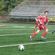 Avery Stewart (left, in red uniform) moves the ball toward the Midcoast goal as Sullivan Fink (also in red) waits for his pass in U-13 action in Falmouth. Courtesy of Marcy Tilas