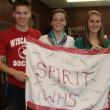 This spirit flag made under a previous Wiscasset High School student council will likely make an appearance at a January 31 rally the school is planning as part of a competition put on by Portland television station WGME. Pictured from left are current student council president Logan Grover, vice president Briana Goud and secretary Sarah Hanley. SUSAN JOHNS/Wiscasset Newspaper