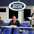 Belfast City Councilor Mike Hurley, right, searches for safe topics on the agenda at the Nov. 12 meeting of the RSU 20 board of directors. Seated are Belfast board members Caitlin Hills and Alan Wood. (Photo by Ethan Andrews)