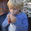 A boy eats an oyster. 