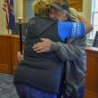 Edgar Lewis hugs family.