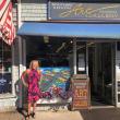 Sandra Chase Morrissey stands in front of her painting in a window at BRAF in 2022. FB photo