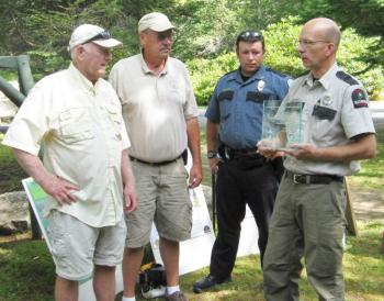 Accepting the Firewise Community Award from Kent Nelson, Maine Forestry Service Ranger, right, are, from left, Curt Norred, the Firewise Community Board president; Glenn Townsend, retiring Boothbay Harbor Fire Chief; and Nick Upham, Asst. Fire Chief.