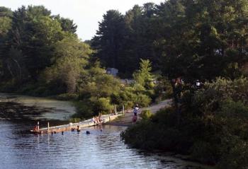 Swimmers and sunbathers enjoy hot, humid days along Nequasset Brook in Woolwich. Selectmen hope to make improvements to the town park and mitigate any conflicts between boaters and swimmers there. JOHN MAGUIRE/Wiscasset Newspaper