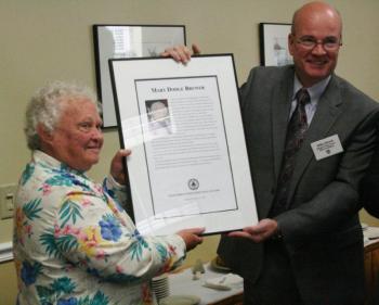 Mary Brewer receives the plaque honoring her as a 2012 inductee into the Maine Press Association's Hall of Fame from Mike Dowd, president of the MPA, at the ceremony held at the Hilton Garden Inn in Freeport October 13. SARAH MORLEY/Boothbay Register