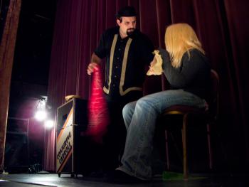 Conjuring Carroll performs a magic trick on stage at the Colonial Theatre with help from Lexi Richard. (Photo by Ethan Andrews)