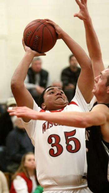 Dylan McMahon pulls down a rebound in Wiscasset’s game with St. Dom’s on Wednesday. Courtesy of Brion Controvillas