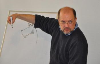 Below: Jeff Pert puts the finishing touches on a cartoon moose Saturday at the Boothbay Harbor Memorial Library. BEN BULKELEY/Boothbay Register