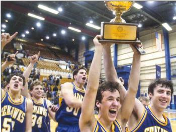 Seahawks co-captains Ian McConnell and Bob Deetjen raise the gold ball high as the 2001 Seahawks champions celebrate their state title at the Bangor Auditorium.