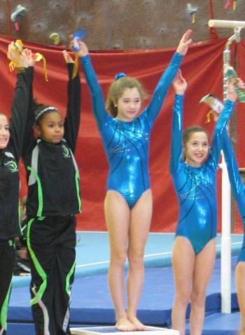 Boothbay gymnast Colette Perry, center, winner of the Level 4, 10-plus division at the Bath gymnastics meet February 3. Courtesy of Gina Perry