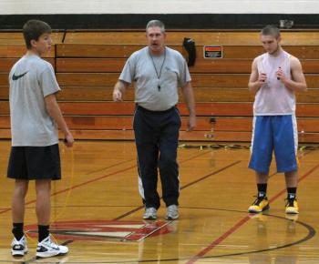 Coach Dana Lawrence, center, works on conditioning with J. D. Souza, left and Austin Haskell, right, at a December 2012 practice. KATHY ONORATO/Wiscasset Newspaper