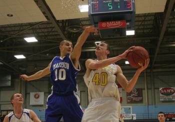 John Hepburn's leaping ability allows him to get off shots, including this shot over Madison's Dylan Price during last week's tournament game. KEVIN BURNHAM/Boothbay Register