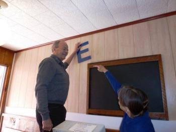 Peter and Nancy Gilchrist argue playfully about what angle the letters spelling Ebb Tide should hang on the wall. KATRINA CLARK/Boothbay Register