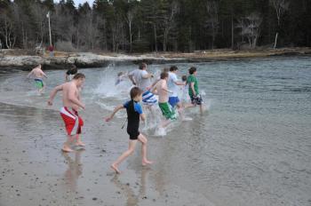 Swimmers run into the ocean at Hendrick's Head Beach in Southport March 14. BEN BULKELEY/Boothbay Register