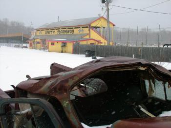 A smashed and rusted car outside the Unity Raceway grandstands on March 4. The track closed last August due to financial troubles but was recently leased by Last Chance Motorsports. The Washburn-based company plans to reopen the track in May. (Photo by Ethan Andrews)