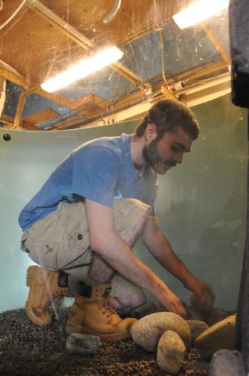 Colin Marshall places rocks in a tank as opening day draws near for the Maine State Aquarium. BEN BULKELEY/Boothbay Register.