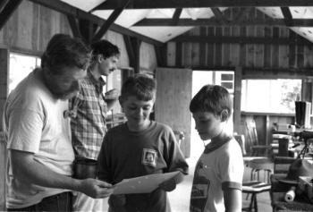 July, 1991: Scouts Eric Schmidt and Gearry Judkins seem happy with a freshly shot target during merit badge work. Instructors Earl Leavitt, foreground, and Carl Schmidt were among several certified members available for BSA and Hunter Safety programs. Courtesy of Lucy Schmidt