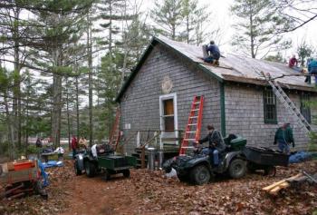 Spring 2005: Almost 50 years to the day from when construction first commenced, club volunteers gather to install a much needed new roof on their club house. Courtesy of Lucy Schmidt