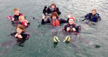 High School Sailing Club members brave the waters off Boothbay Harbor before their first practice of the spring. From left are, front: Madison Gaudette, Sarah Caron; middle: Nolan Conlin, Sherm Brewer, Sally Jarmusz; back: Liam Conlin and Jake Brewer. Courtesy of Andy Holmes