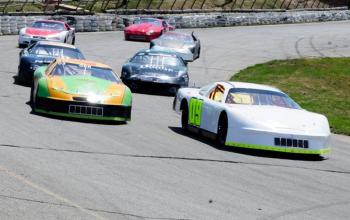 Darrin Ripley, of Appleton, driving the #9 car, is the first to cross the finish line in the Late Model Sportsman feature at Wiscasset Speedway on Saturday, April 27. courtesy of Peter Taylor, Wiscasset Speedway