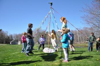 Two groups of Southport students helped wrap colored ribbons during the Pagan tradition of the Maypole. BEN BULKELEY/Boothbay Register