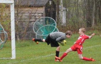 Midcoast striker Will Shafer charges after the ball during the second half of play at Clifford Playground. Shaffer scored on a breakaway in the opening seconds of the match. SUE MELLO/Boothbay Register