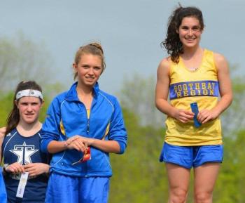 Sophia Thayer, right, and Hannah Morley, center, meet at the winners' podium at the MVC Championships in Augusta. The two teammates had a friendly rivalry all season, and will now advance to the state championships to compete in the 1600 and 3200 meter races on June 1. Courtesy of Aquilino Alamo  