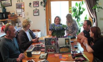 The family of Dane Bonang looks through photos and reminisces about his life. Left to right are: his parents, Allan and Mary Bonang; his cousins Beckie and Kendra Alexander; his brother Stephen Bonang; and Jordan Fitch. KATHY ONORATO/Wiscasset Newspaper