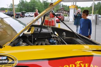 Nathaniel Mann, right, gets a look at the No. 22 Shell/Pennzoil Ford Fusion at Lil' Mart in Wiscasset.