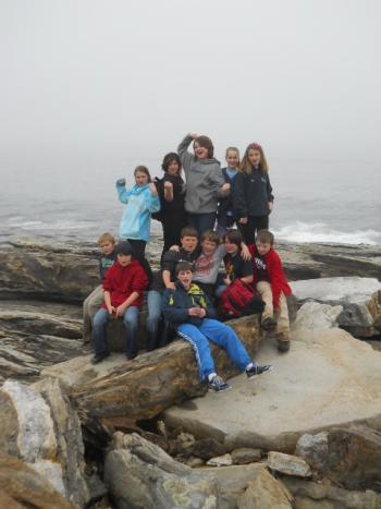 Fifth graders take a break to appreciate the rocky shore of Damariscove on their way to the East Tower. Courtesy of Rita Arnold