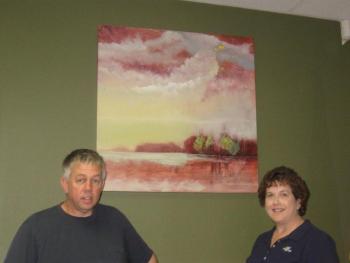 Allen Bunker stands in front of one of his paintings and beside First Federal branch manager Jean Huber. Courtesy of Sandy Terry