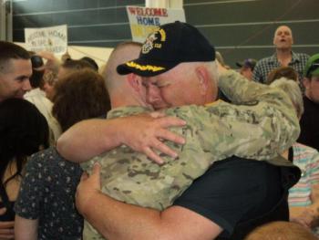 Peter Greenleaf hugs his son, Pvt. Nick Greenleaf, upon his return to Maine June 15. Courtesy of Isaac Luken