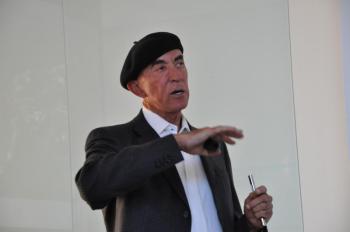 Dr. Ed Bosarge talks to the crowd July 16. Bosarge, who has a residence in Southport, talked at Bigelow Laboratory's Cafe Scientifique about Over Yonder Cay, a renewable energy resort. BEN BULKELEY/Boothbay Register