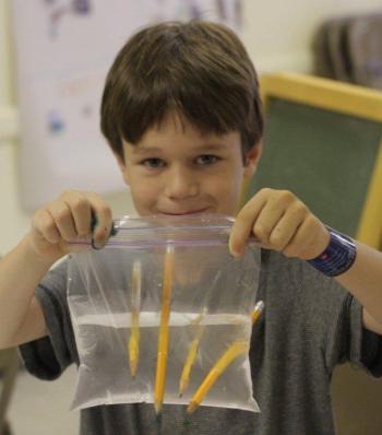 Benno Hennig shows his leak proof bag after learning about polymers. Courtesy of Seeds of Knowledge Education Center